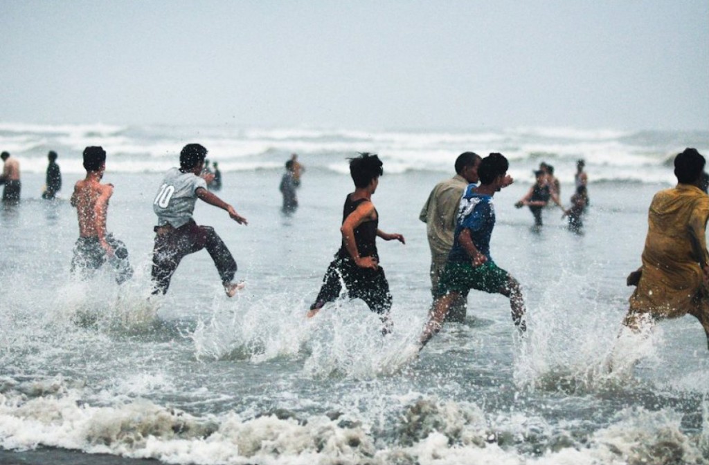 Boys running into the Indian Ocean at Clifton Beach